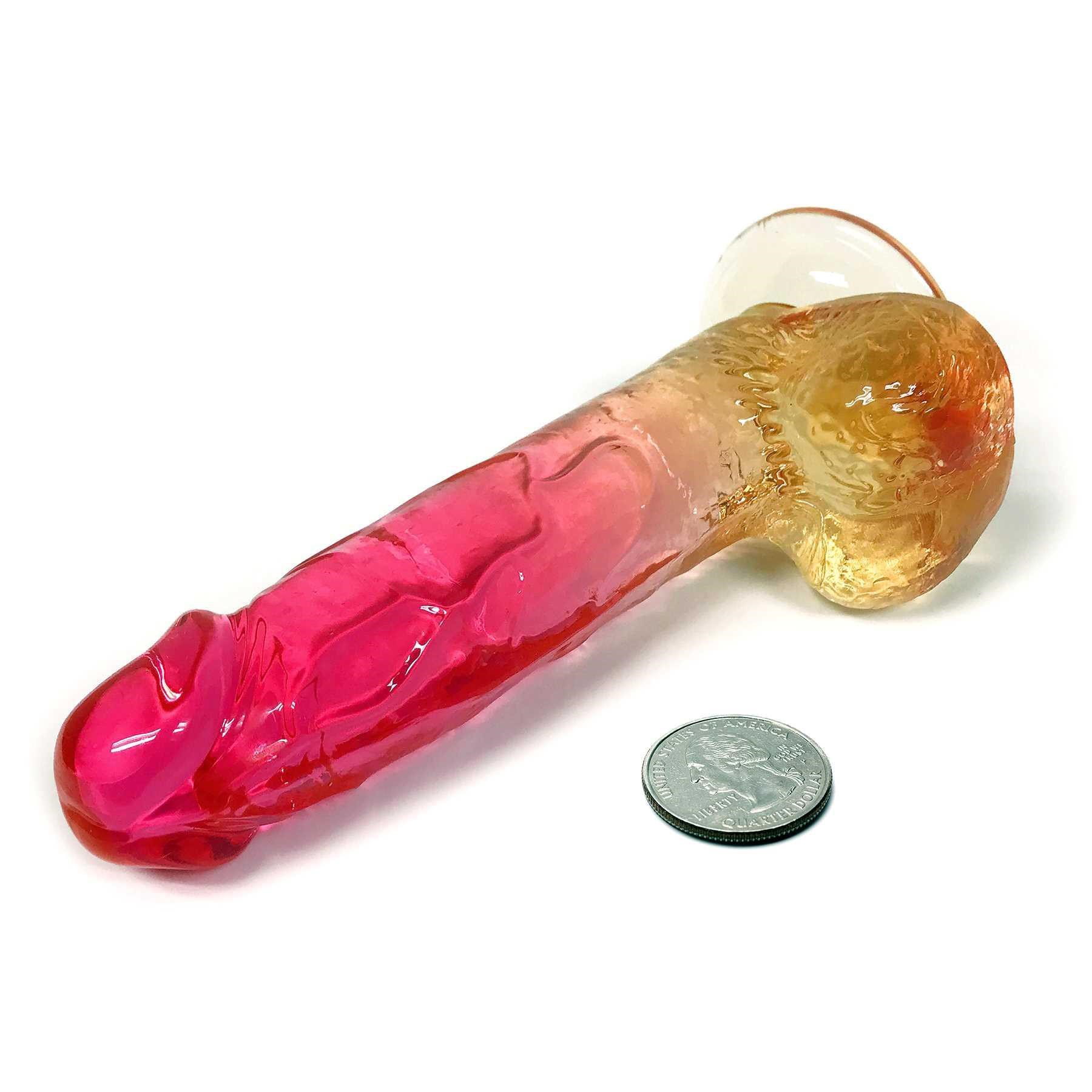 SHADES FADE TO COOL 8 INCH DILDO next to a quarter to show scale