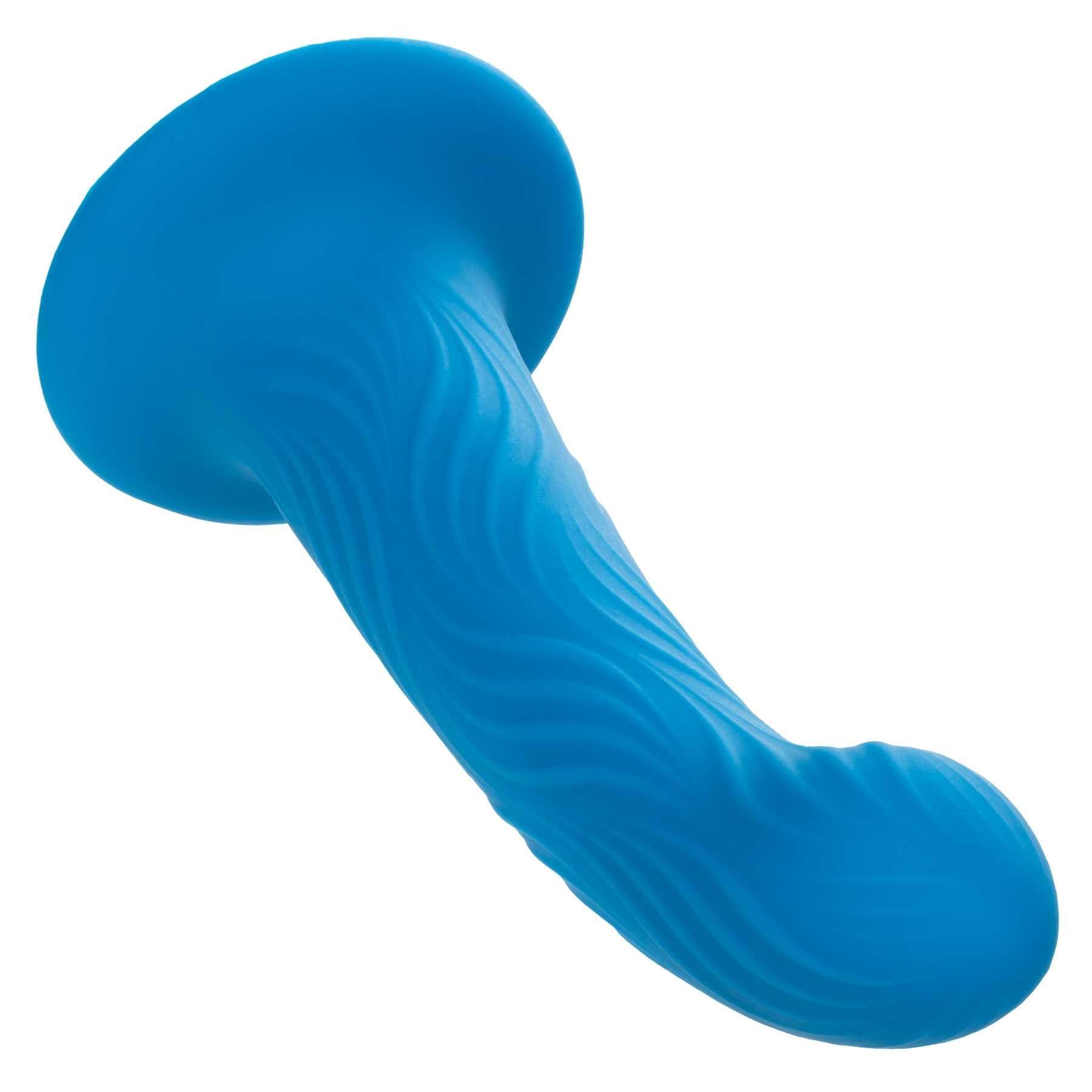 Wave Rider Ripple Liquid Silicone Dildo laying on table tip end forward