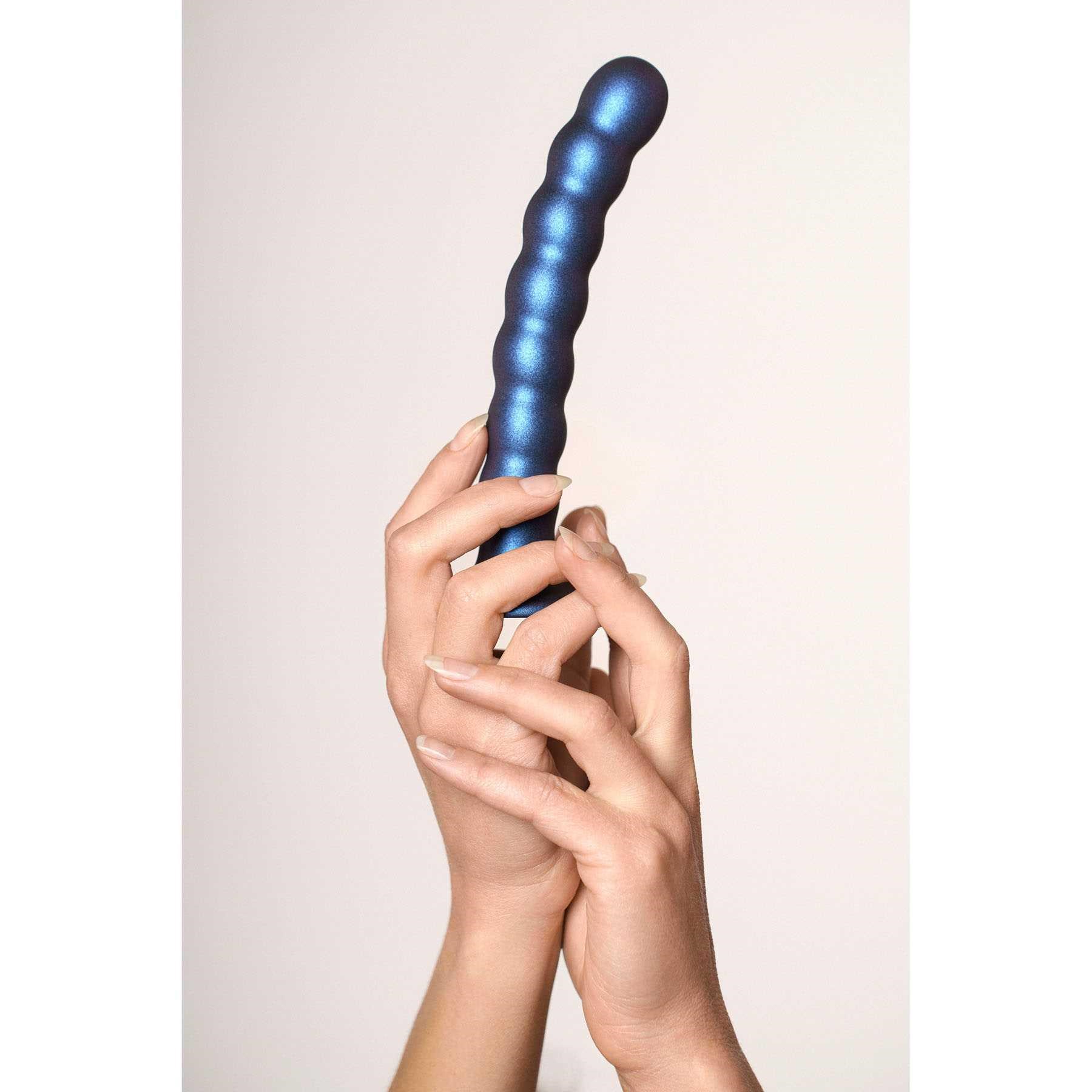 OUCH! METALLIC SILICONE 6.5 BEADED G-SPOT DILDO hand holding upright