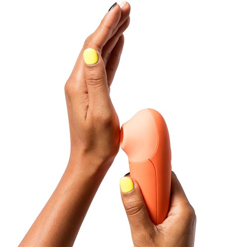 Romp Switch X Pleasure Air Clitoral Stimulator in hand 1