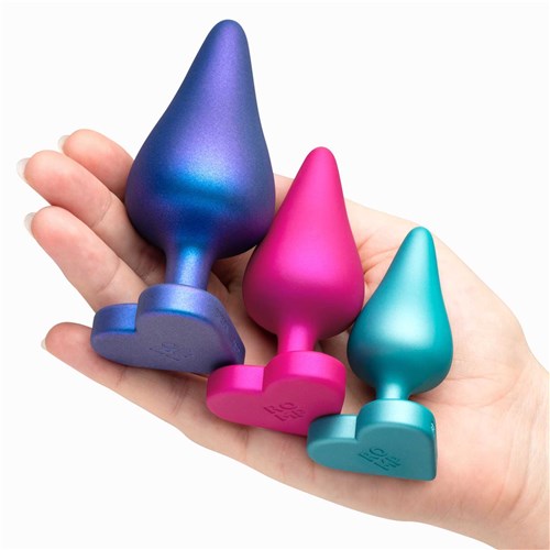 Romp Luster Anal Training Kit hand holding all 3 plugs