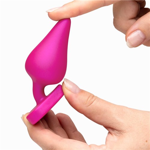 Romp Luster Anal Training Kit hand flexing pink plug